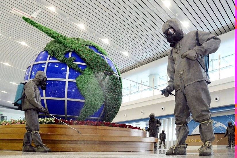 Các nhân viên phun thuốc khử trùng tại sân bay quốc tế Bình Nhưỡng , Triều Tiên. Ảnh: KCNA