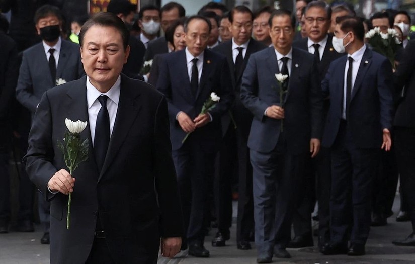 Tổng thống Hàn Quốc Yoon Suk-yeol cầm hoa tưởng niệm các nạn nhân trong thảm kịch Itaewon. Ảnh: Reuters