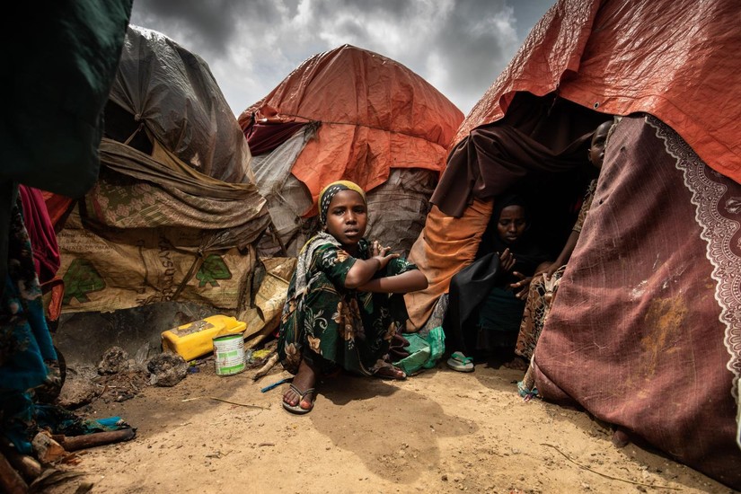 Một bé gái ngồi bên ngoài căn lều dành cho những người di tản ở Mogadishu, Somalia, tháng 10/2022. Ảnh: UNICEF